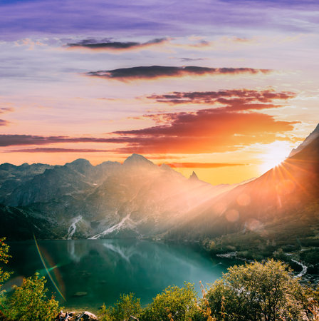 Tatra National Park, Poland. Famous Mountains Lake Morskie Oko Or Sea Eye Lake In Summer Evening. Beautiful Sunset Sun Sunshine Sunrays Above Tatras Lake Landscapeの写真素材