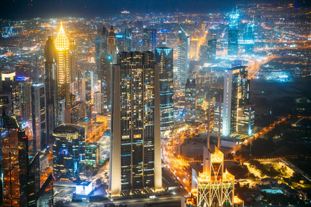 Dubai, UAE, United Arab Emirates - May 25, 2021: Aerial View Of Urban Cityscape Skyline At Night. City Background Of Illuminated Cityscape With Skyscrapers And Towers In Dubai. Street Night Traffic With Illuminations. High quality photoのeditorial素材