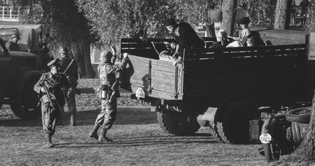 Dobrush, Belarus. - September 3, 2022: German Vehicles From World War Ii. Reconstruction Of Forced Removal Of People During World War Ii. Civilians And Infantry Soldiers. Black And White Videoのeditorial素材