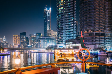 Dubai Marina Port, UAE, United Arab Emirates - May 19, 2021: Night Walk On Tourist Boat, Sightseeing Boat Sailing On Dubai Marina. Night View Of Dubai Marina Is District in Dubai, United Arab Emiratesのeditorial素材