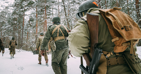Heroes Of War. Re-enactors Dressed As American Infantry Soldier Marching Through Forest Road In Cold...