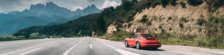 Red Colour Porsche 911 Carrera 2 Coupe In Motion On Spanish Motorway Highway Freeway Road.