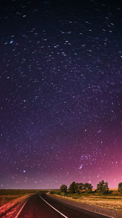 Blue Night Starry Sky Above Country Asphalt Road In Countryside And Green Meadow. Night View Of...