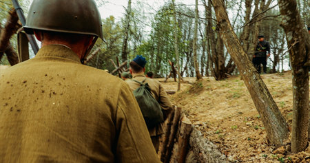 Reconstruction Of Battles World War Ii. Re-enactors Dressed As Soviet Russian Soldiers Take Up Fighting Positions In Trenches. Position Defense. Soldiers Aiming With Riflesの写真素材
