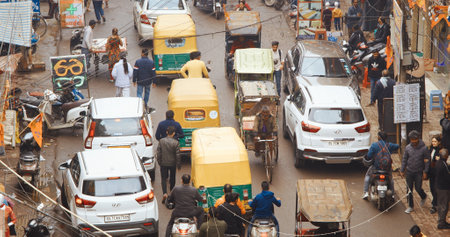 New Delhi, Delhi, India - February 04, 2024: Traffic On The Main Bazar road Street Paharganj. Cars, Motorcycles, Auto Rickshaw Or Tuk-tuk Moving On Street In morning. View on hotels and shopping placesのeditorial素材