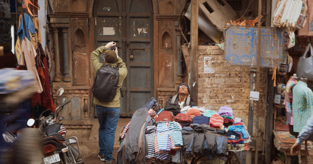 New Delhi, Delhi, India - February 04, 2024: A man sells clothes from his cart On The Main Bazar road Street Paharganj.のeditorial素材