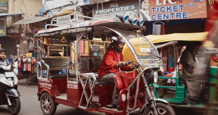 New Delhi, Delhi, India - February 04, 2024: Traffic On The Main Bazar road Street Paharganj. Cars, Motorcycles, Auto Rickshaw Or Tuk-tuk Moving On Street In morning. View on hotels and shopping placesのeditorial素材
