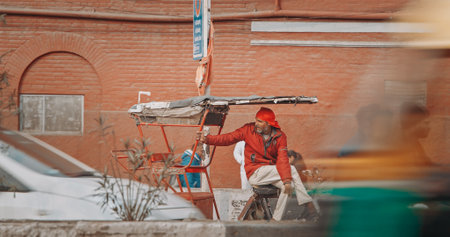 New Delhi, Delhi, India. Indian man carries loaded cargo on a cargo bike. Traffic On The Desh Bandhu Gupta road street. Cargo Lorry Trishaw pedicab moving on a bicycle along the street. Cars, Motorcycles, Auto Rickshaw Or Tuk-tuk Moving On Street In morniのeditorial素材