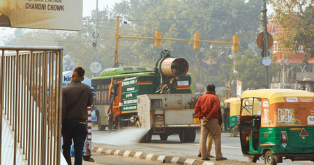 New Delhi, Delhi, India. Fire truck spraying water over Delhi streets amid pollution emergency. The government plans to spray the city with water in an attempt to clear the toxic smog cloud.のeditorial素材