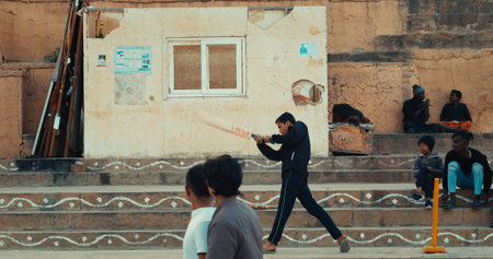 Varanasi, India. Young Guys Playing Cricket On Steps Of Ganges Embankment. Playing Cricket At Varanasi Ghats . Leisure Activity. Every Day Life Of India. Young Sports Lifeのeditorial素材