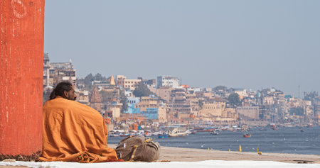 Varanasi, Uttar Pradesh, India. Man standing on Kshemeshvar ghat steps after morning ritual wash in river. Indian men take their morning bath in sacred waters of the Ganges River.のeditorial素材