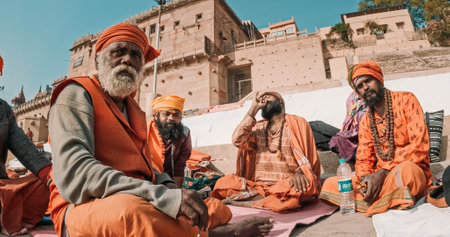 Varanasi, Uttar Pradesh, India. Group of Sadhus - indian holymen sitting on the ghat ground at morning. Raja Ghat Ganges river.のeditorial素材