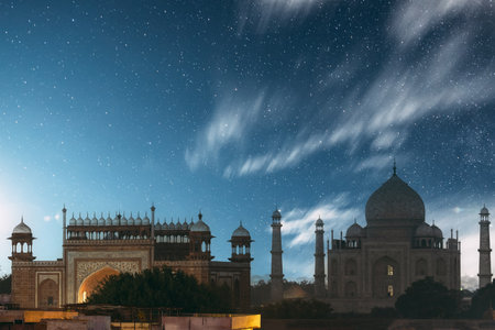 Taj Mahal In Agra, Uttar Pradesh, India. Night Starry sky above Taj Mahal. Seven World Wonders. Fabulous Taj Mahal Travel Concept. Crowds Of Tourists Visit Taj Mahal. Indian Islamic Heritage At Night Time.の写真素材