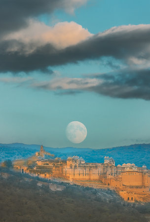 Jaipur, Rajasthan, India. Moon Rising Above Amer Fort Or Amber Fort, Amer, Rajasthan, India In sunset Time. Amer Palace Is Great Example Of Rajput Architecture. Amber Fort Principal Tourist Attraction In Jaipur. Sunset Dusk Of Amer Fort. People visiting Amber Fortの写真素材