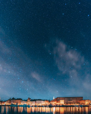 Stockholm, Sweden. Scenic Famous View Of Embankment In Old Town Of Stockholm In Night Lights. Great Church Or Church Of St. Nicholas And Royal Palace. Famous Popular Destination Scenic Place In Lightの写真素材