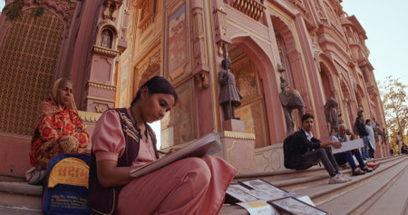 Jaipur, Rajasthan, India. Indian woman street artist paints a picture near Patrika Gate at Jawahar Circle. Old Pink city.のeditorial素材