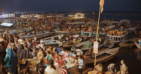 Varanasi, Uttar Pradesh, India. Many people on boats waiting start night Ganga Maha Aarti ceremony on Dashashwamedh Ghat. Night time illumination lights. People visiting Puja ritual.のeditorial素材