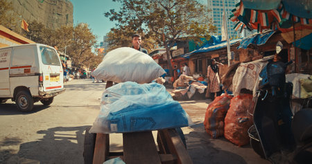 Mumbai, India. At Street Near Dhobi Ghat. Man Carries Washed Clean Clothes On Old Cart. Dhobi Ghat Is Open Air Laundry. Rich And Poor. Every Day Life Of India. One Of Largest Outdoor Laundryのeditorial素材