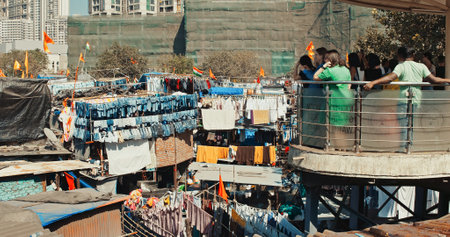 Mumbai, India. Tourists On Observation Deck Look At Dhobi Ghat Is Open Air Laundry. One Of Largest Outdoor Laundry. Popular Attraction Among Foreign Tourists. Class Differences Between People. Rich And Poor. Luxury And Povertyのeditorial素材