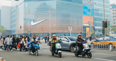 Beijing, China. Traffic On Wangfujing Street. Popular Shopping Street In Beijing. Official Store Of Nike On Background. Cars, Motorcycles Moving By Wangfujing Street. City Traffic On Streetのeditorial素材