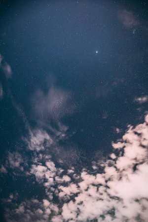 Real Night Sky Stars with some clouds cloudy sky. Natural Starry Sky Blue Color Background. unusual view natural backgroundの写真素材