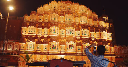 Jaipur, Rajasthan, India. Hawa Mahal Palace In Night Illuminations. Tourist Takes Photo Of Palace....