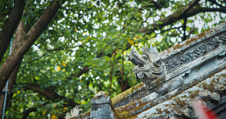 Chengdu, Sichuan, China. Carved Dragon Heads Decorate Roof. Figurines On Roof Of Temple. Chinese...