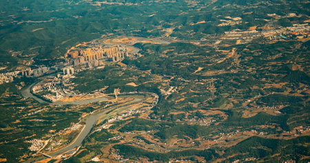 View From Airplane Window On Suburb Of Chengdu, China. Mountainous Landscape Of China. Porthole View Or Called Bulls-eye Window. Chengdu Is Capital City Of Chinese Province Of Sichuan. High-rise Houses Elevated View Cityscape Skyline. Urban Residential Areas. Real Estateの写真素材