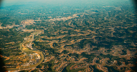 View From Airplane Window On Suburb Of Chengdu, China. Mountainous Landscape Of China. Porthole View Or Called Bulls-eye Window. Dense Private Buildings. Chengdu Is Capital City Of Chinese Province Of Sichuanの写真素材