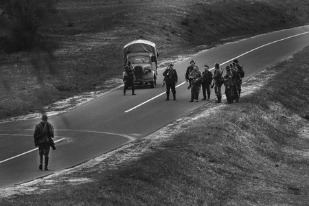 Mogilev, Belarus. - May 07, 2022: Re-enactors Dressed As German Infantry Soldier In World War Ii Waiting Signal To Attack. Reconstruction Of Battles World War Ii For Mogilev. Black And White Videoの写真素材