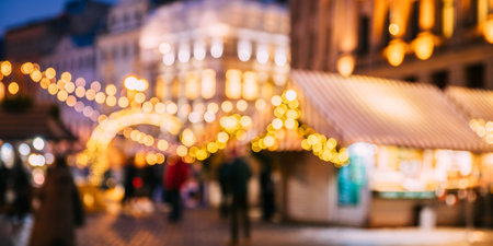 Abstract Blurred Bokeh Boke Background Of Traditional Christmas Market In Night European Town. Evening Street Decorated With Festive Christmas Xmas New Year Illuminationsの写真素材