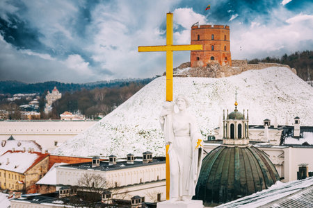 Vilnius Lithuania. Pediment Of Cathedral Basilica Of St. Stanislaus, St. Vladislav With Statues Of St. Elena And St. Stanislaus, Tower Of Gediminas Or Gedimino In Winter Dayの写真素材