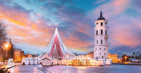Vilnius, Lithuania. Christmas Tree On Background Bell Tower Belfry Of Vilnius Cathedral At Cathedral Square In Evening New Year Christmas Xmas Illuminations. Unesco World Heritage Site. Altered Skyの写真素材
