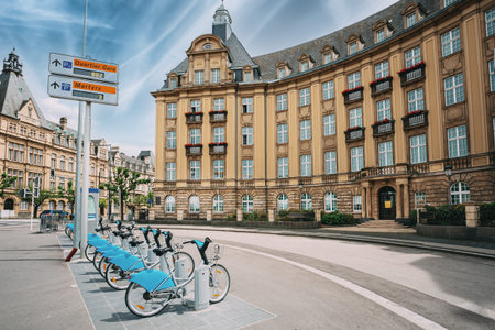 LUXEMBOURG. Row of city bikes for rent on a background of bank building