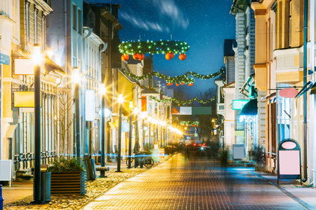 Parnu, Estonia. Night View Of Famous Ruutli Street With Old Buildings, Restaurants, Cafe, Hotels And Shops In Festive Evening Night Christmas Xmas New Year Illuminations . Night starry stars sky.の写真素材