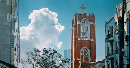 Towering Church with Cross Set Against Clear Sky in Urban Location Shanghai, Chinaの写真素材