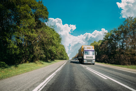 Truck On Country Road. Tractor Unit, Prime Mover, Traction Unit In Motion On Countryside Road In Europe. Business Transportation And Trucking Industry Conceptの写真素材