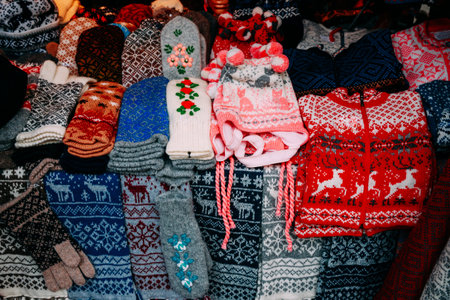Traditional Christmas Winter Market Trading Houses With Warm Clothes, Wear And Hats. Colorful Knitted Traditional European Warm Clothes - Mittens and Scarfs. Xmas Souvenir From Europe.の写真素材