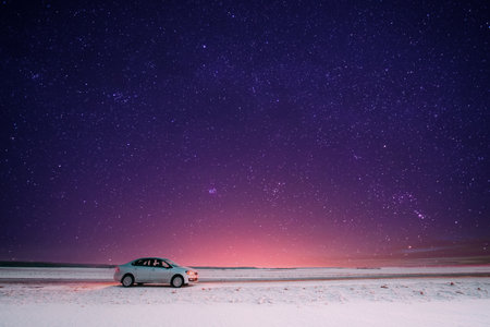Car Sedan In Country Road At Winter Eveningの写真素材