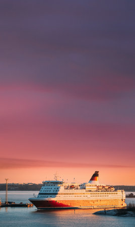 Helsinki, Finland. View Of Modern Ferryboat Floating Near Blekholmen Valkosaari Island At Sunrise Sky.の写真素材