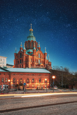 Helsinki, Finland. Uspenski Cathedral In Evening Illuminations Lights. Eastern Orthodox Cathedral Dedicated To Dormition Of The Theotokos - Virgin Mary. Night stars shining above streetの写真素材