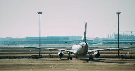 Shanghai, China - November 3, 2024: China Eastern Airlines aircraft on airport apron with pushback tug and ground crew preparing for departure.のeditorial素材