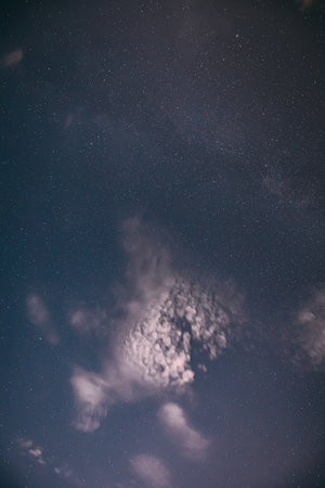 Real Night Sky Stars with some clouds cloudy sky. Natural Starry Sky Blue Color Background. unusual view natural backgroundの写真素材