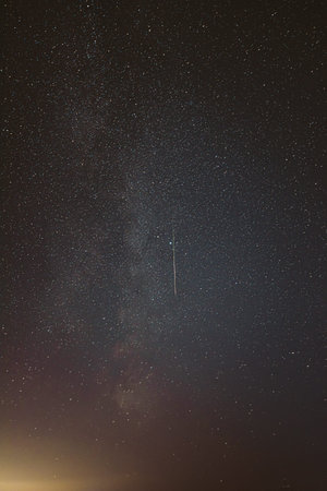 Real Night Sky Stars With Milky Way Galaxy. Natural Starry Sky Background with meteor trails lights....