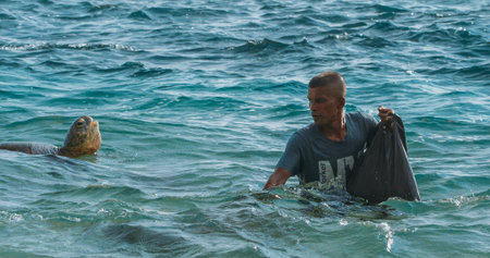 Marine Conservation: Young Man with Sea Turtle Underwater