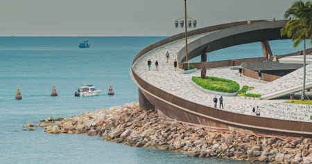 Curved seaside promenade with walking visitors, Phu Quoc Vietnam
