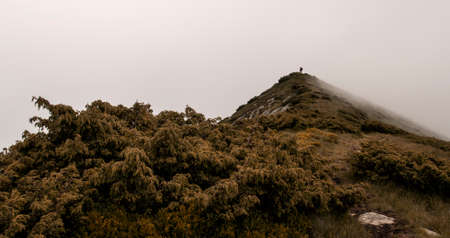 Lost in fog   Man lost in fog on mountain ridgeの写真素材