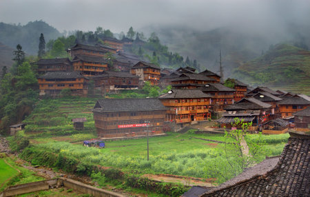 GUANGXI PROVINCE, CHINA - APRIL 3: The village of ethnic Yao, National Minorities in China, Yao village Dazhai, Southwest China, April 3, 2010. Wooden houses on hillside, Dazhai, near Longsheng, Guangxi, China. Yao minoritys homeのeditorial素材
