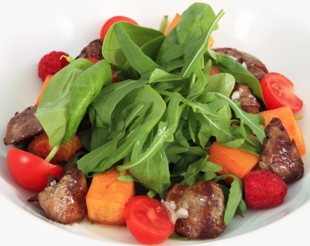 The food on the plate, snack, restaurant dish  A salad with baked pumpkin and a chicken liver の写真素材