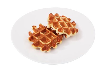 On a white plate is a two Belgian waffles, Isolated image on a white , no body. Soft wafflesの写真素材